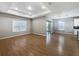 Spacious living room featuring wood-look tile flooring, recessed lighting, and natural light from sliding glass doors at 1038 Commuter Dr, Deltona, FL 32738