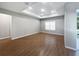 Spacious living room with modern tray ceiling, recessed lighting, and wood-look tile floors at 1038 Commuter Dr, Deltona, FL 32738