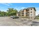 Condo building featuring multiple balconies, ample parking, and a well-maintained exterior at 1060 Lotus Pkwy # 1012, Altamonte Springs, FL 32714