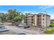 Condo building featuring multiple balconies with ample parking and a well-maintained exterior at 1060 Lotus Pkwy # 1012, Altamonte Springs, FL 32714