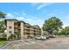 A condo building with multiple balconies, and parking with designated handicapped spaces at 1060 Lotus Pkwy # 1012, Altamonte Springs, FL 32714