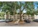 Multi-story condo building surrounded by trees, featuring multiple balconies with ample parking at 1060 Lotus Pkwy # 1012, Altamonte Springs, FL 32714