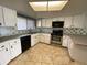 Well-lit kitchen featuring white cabinets, stainless steel appliances, and decorative backsplash at 1060 Lotus Pkwy # 1012, Altamonte Springs, FL 32714