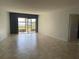 Open living room with tile flooring, sliding glass door, and view of outdoor scenery at 1060 Lotus Pkwy # 1012, Altamonte Springs, FL 32714