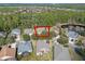 Aerial view of home with a spacious lawn close to a lake at 1112 Heron Point Way, Deland, FL 32724