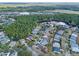 Aerial view of homes in a planned community with mature trees and lake access at 1112 Heron Point Way, Deland, FL 32724