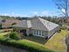 Aerial view of the house featuring a screened in patio and manicured lawn at 1112 Heron Point Way, Deland, FL 32724