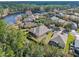 Aerial view of home showcasing lush trees and a serene lakeside backdrop at 1112 Heron Point Way, Deland, FL 32724