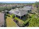 Aerial view of the house featuring a spacious lawn and solar panels at 1112 Heron Point Way, Deland, FL 32724