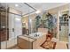 A glass enclosed shower and soaking tub create a spa-like atmosphere with a decorative wall at 1112 Heron Point Way, Deland, FL 32724