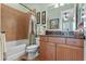 Inviting bathroom with a shower-tub combo, wood vanity, and decorative accents at 1112 Heron Point Way, Deland, FL 32724