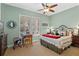 Charming bedroom with mint walls, shuttered windows, and decorative furnishings at 1112 Heron Point Way, Deland, FL 32724