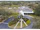 Aerial view of a grand community center featuring lush landscaping and circular driveway at 1112 Heron Point Way, Deland, FL 32724