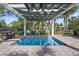 Community hot tub under a pergola, with seating and landscaping around the pool at 1112 Heron Point Way, Deland, FL 32724