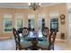 Bright dining area with a glass table, decorative chairs, and ample natural light at 1112 Heron Point Way, Deland, FL 32724