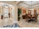 Dining room featuring a chandelier, tray ceiling, and views into the front entrance hall at 1112 Heron Point Way, Deland, FL 32724