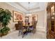 Formal dining room with elegant chandelier, wooden table set, and decorative wall art at 1112 Heron Point Way, Deland, FL 32724