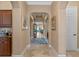 Elegant hallway with arched doorways and tile flooring, leading to various rooms in the home at 1112 Heron Point Way, Deland, FL 32724