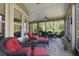 Relaxing screened patio with red and white striped lounge chairs and ceiling fan at 1112 Heron Point Way, Deland, FL 32724