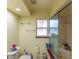 Bright bathroom featuring a glass-door shower, window, toilet, and shelves for organized storage at 1221 Forest Cir, Altamonte Springs, FL 32714