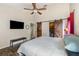 Spacious bedroom with wood-look floors and sliding barn door to the en-suite bathroom at 12972 Broakfield Cir, Orlando, FL 32837