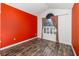 Bedroom featuring wood-look floors and a large window at 12972 Broakfield Cir, Orlando, FL 32837