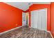 Bedroom featuring wood-look floors and a double door closet at 12972 Broakfield Cir, Orlando, FL 32837