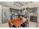 Modern kitchen with dark cabinetry, stainless steel appliances, and a dining table, perfect for culinary enthusiasts at 12972 Broakfield Cir, Orlando, FL 32837