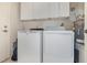 Functional laundry room with appliances and overhead cabinets for storage at 12972 Broakfield Cir, Orlando, FL 32837