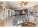 Open-concept living space with a ceiling fan seamlessly connects to the kitchen, perfect for entertaining guests at 12972 Broakfield Cir, Orlando, FL 32837