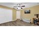 This bedroom features hardwood floors, a ceiling fan, and a wall-mounted television at 12991 Sw 72Nd Terrace Rd, Ocala, FL 34473