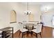 Bright dining area with modern glass top table, comfortable seating, and wood flooring at 12991 Sw 72Nd Terrace Rd, Ocala, FL 34473