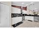 Well-equipped kitchen featuring stainless steel appliances and ample white cabinetry at 12991 Sw 72Nd Terrace Rd, Ocala, FL 34473