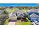 Aerial view of a two-story home with green lawn, landscaping, and two-car garage in a neighborhood with mature trees at 137 Kays Landing Dr, Sanford, FL 32771