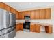 Kitchen showcasing stainless steel appliances and wood cabinets at 137 Kays Landing Dr, Sanford, FL 32771