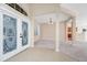 Bright living room showcases neutral paint, carpeted floors, an elegant chandelier, and a view into the foyer at 137 Kays Landing Dr, Sanford, FL 32771