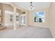 Light-filled living room with carpet, neutral walls, chandelier, and an inviting view into the foyer at 137 Kays Landing Dr, Sanford, FL 32771