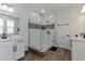 Well-appointed bathroom featuring glass-enclosed shower, double vanity with white cabinets, and stylish tile accents at 13819 Lanyard Way, Winter Garden, FL 34787