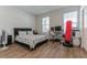 Bedroom with wood floors features a black bed frame, desk with computer, and a decorative red punching bag at 13819 Lanyard Way, Winter Garden, FL 34787