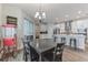 Dining room with a table, wood-look tile flooring, and modern lighting at 13819 Lanyard Way, Winter Garden, FL 34787