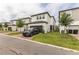 Modern two-story home boasts a well-kept lawn, gray driveway, and stylish curb appeal at 13819 Lanyard Way, Winter Garden, FL 34787