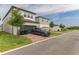 Stylish two-story home with a gray driveway, lush front yard, and well-maintained landscaping at 13819 Lanyard Way, Winter Garden, FL 34787