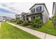 Charming two-story home with well-maintained lawn and landscaping on a sunny day at 13819 Lanyard Way, Winter Garden, FL 34787