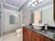 Bathroom featuring a granite vanity, glass shower with decorative tile and great lighting at 1502 Hempel Ave, Windermere, FL 34786