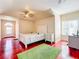 Bedroom with bright light, red floors, and a ceiling fan at 1502 Hempel Ave, Windermere, FL 34786