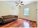 Bedroom with gleaming hardwood floors, neutral walls, and ample natural light from the window at 1502 Hempel Ave, Windermere, FL 34786