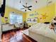 Bright bedroom is decorated with fun decor and features a hardwood floor and closet at 1502 Hempel Ave, Windermere, FL 34786