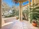 Covered entryway with tile flooring, decorative columns, chandelier, and garden views at 1502 Hempel Ave, Windermere, FL 34786