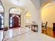 Inviting foyer with chandelier, arched doorways, and tiled floors at 1502 Hempel Ave, Windermere, FL 34786