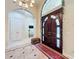 Grand foyer showcasing a large wooden door, decorative rug, and arched doorway at 1502 Hempel Ave, Windermere, FL 34786